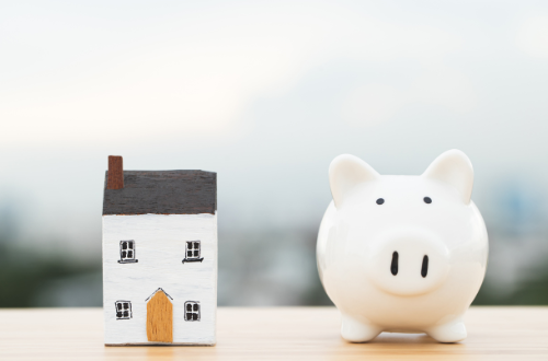 cute piggy back and model house to represent mortgage advice