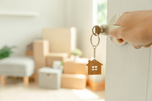 Front door with key in the lock and moving boxes inside – first-time buyer mortgage in Warwickshire